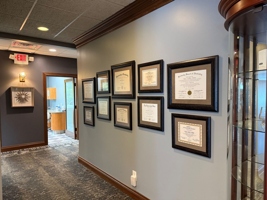 wall with rows of framed certificates
